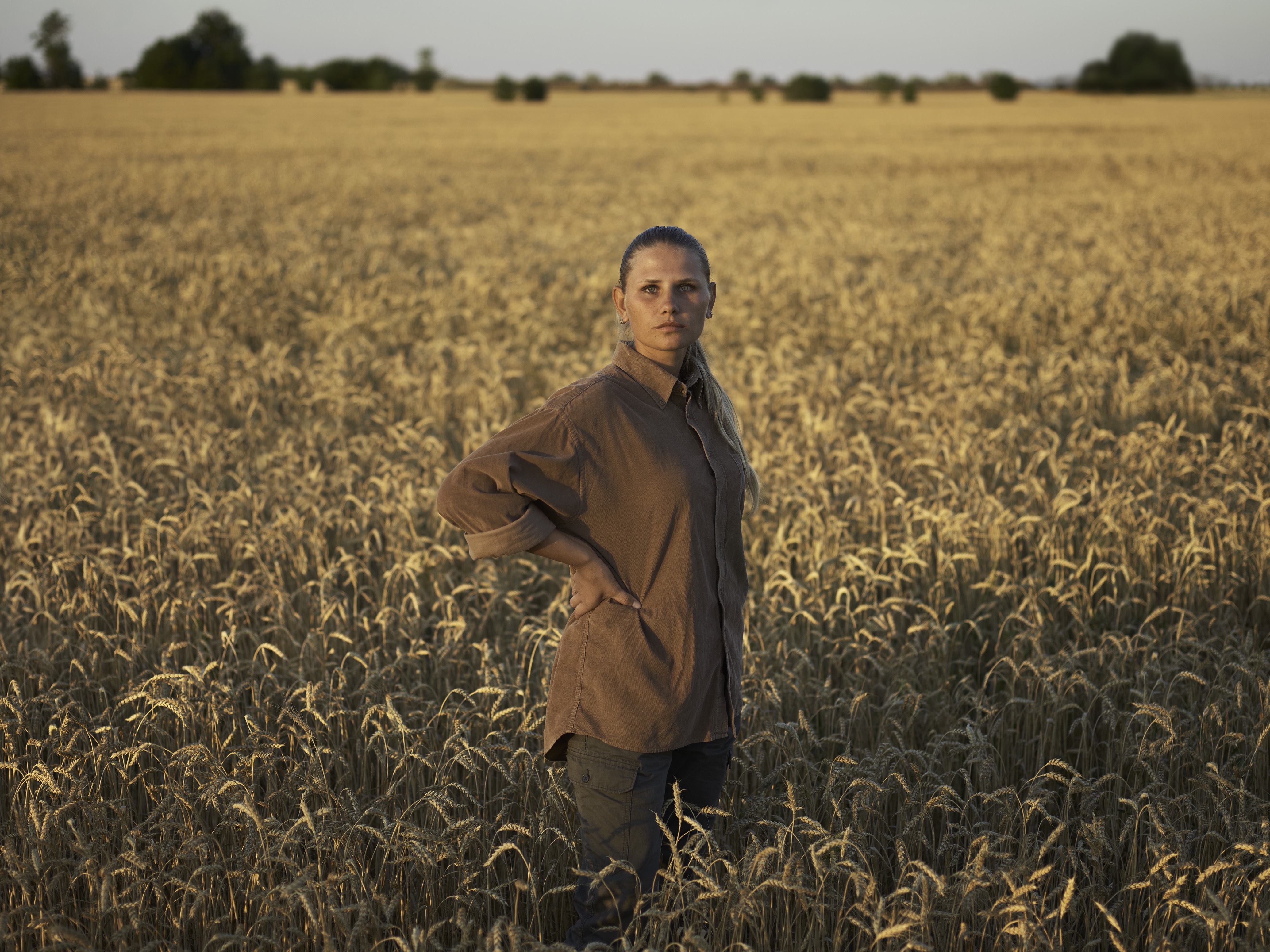 Woman standing in a wheat field